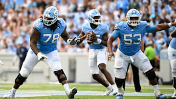 Sep 7, 2024; Chapel Hill, North Carolina, USA; North Carolina Tar Heels quarterback Conner Harrell (15) looks to pass as offensive linemen Trevyon Green (78) and Willie Lampkin (53) block in the second quarter at Kenan Memorial Stadium. Mandatory Credit: Bob Donnan-Imagn Images