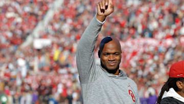 Former Oklahoma running back Adrian Peterson gestures to the crowd during a game against the TCU Horned Frogs.