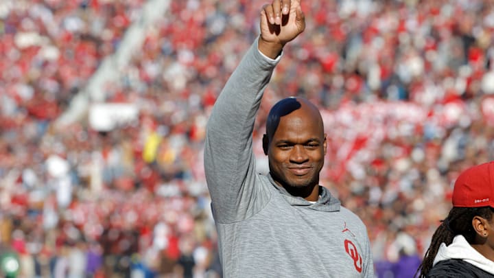 Former Oklahoma running back Adrian Peterson gestures to the crowd during a game against the TCU Horned Frogs.