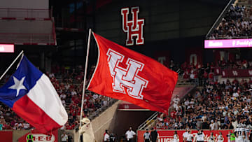 Sep 14, 2024; Houston, Texas, USA; The Minute-men bring the University of Houston flag out after a Houston Cougars touchdown in the second half against the Rice Owls at TDECU Stadium. Mandatory Credit: Sean Thomas-Imagn Images