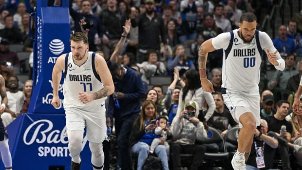 Jan 7, 2023; Dallas, Texas, USA; Dallas Mavericks guard Luka Doncic (77) and center JaVale McGee (00) run back up the court after McGee scores on an alley oop pass by Doncic against the New Orleans Pelicans during the second half at the American Airlines Center. Mandatory Credit: Jerome Miron-USA TODAY Sports