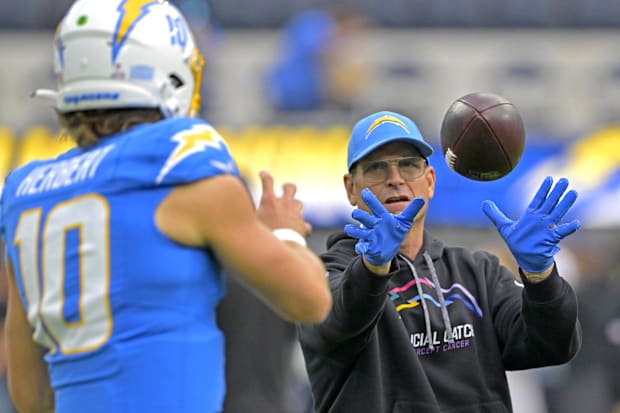 Oct 27, 2024; Inglewood, California, USA;  Chargers’ Justin Herbert warms up with head coach Jim Harbaugh.