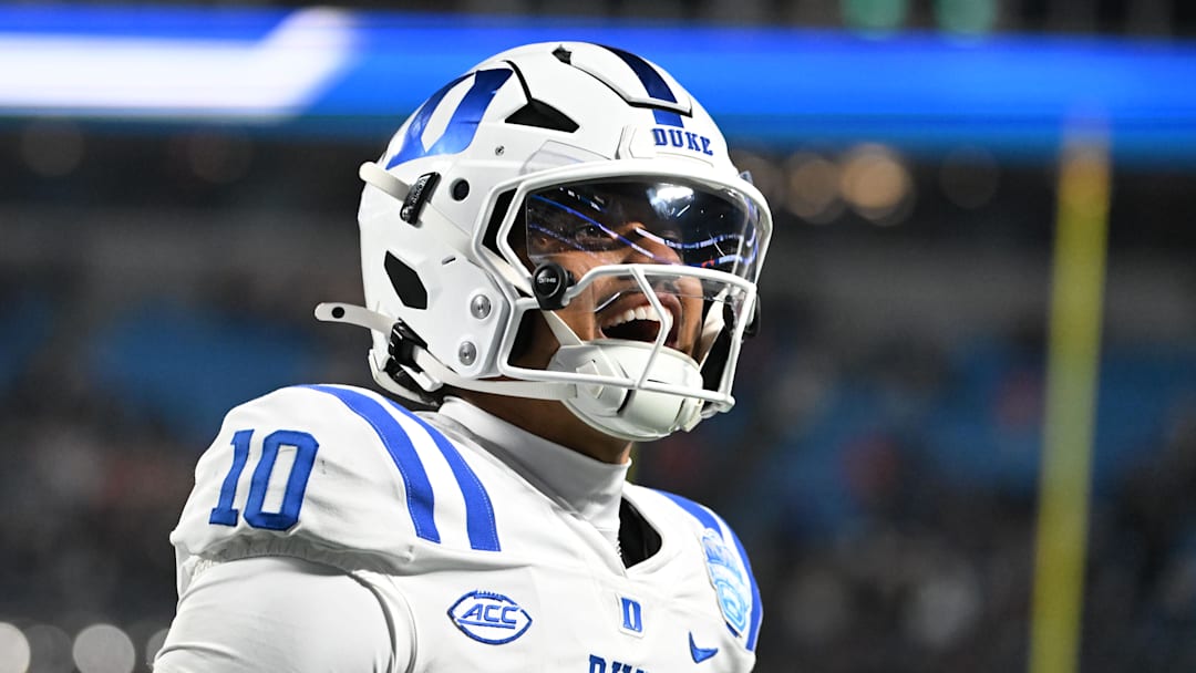 Dec 6, 2025; Charlotte, NC, USA; Duke Blue Devils quarterback Darian Mensah (10) celebrates after the Blue Devils score a touchdown in overtime during the  ACC Championship game at Bank of America Stadium. Mandatory Credit: Bob Donnan-Imagn Images