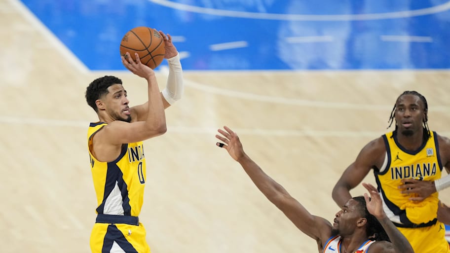 Indiana Pacers guard Tyrese Haliburton (0) shoots the ball against Oklahoma City Thunder guard Cason Wallace (22) during the fourth quarter in game one of the 2025 NBA Finals. | Kyle Terada-Imagn Images