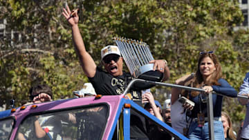 Los Angeles Dodgers manager Dave Roberts (30) celebrates with the Commissioner’s Trophy during the 2024 World Series championship parade near Los Angeles City Hall.