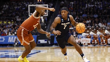 Mar 19, 2025; Dayton, OH, USA; Xavier Musketeers guard Ryan Conwell (7) dribbles the ball defended by Texas Longhorns guard Tramon Mark (12) in the second half at UD Arena. Mandatory Credit: Rick Osentoski-Imagn Images