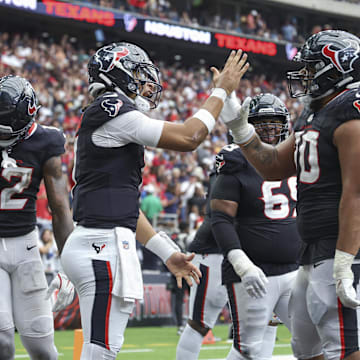 Sep 29, 2024; Houston, Texas, USA; Houston Texans quarterback C.J. Stroud (7) celebrates with center Juice Scruggs (70) after a Texans touchdown during the fourth quarter against the Jacksonville Jaguars at NRG Stadium. Mandatory Credit: Troy Taormina-Imagn Images