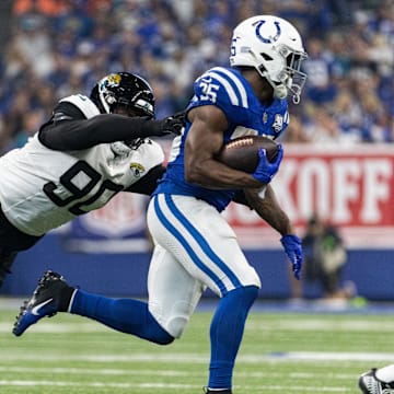 Sep 10, 2023; Indianapolis, Indiana, USA; Indianapolis Colts running back Deon Jackson (35) runs the ball while Jacksonville Jaguars defensive end Angelo Blackson (90) defends in the second half at Lucas Oil Stadium. Mandatory Credit: Trevor Ruszkowski-Imagn Images