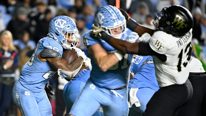 North Carolina Tar Heels running back Omarion Hampton (28) runs as tight end John Copenhaver