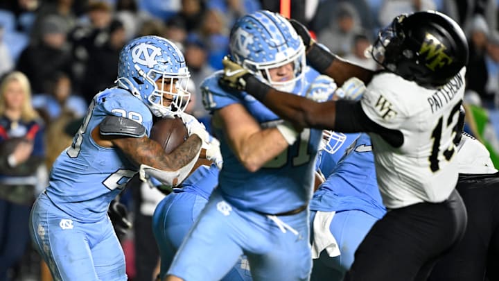 North Carolina Tar Heels running back Omarion Hampton (28) runs as tight end John Copenhaver blocks 