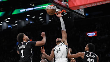 Dec 8, 2024; Brooklyn, New York, USA; Milwaukee Bucks forward Giannis Antetokounmpo (34) dunks the ball as Brooklyn Nets forward Cameron Johnson (2) and Brooklyn Nets center Nic Claxton (33) defend during the second half at Barclays Center. Mandatory Credit: John Jones-Imagn Images