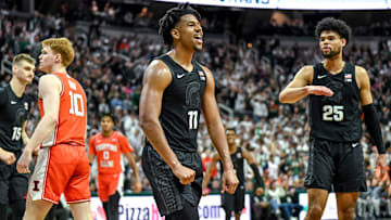 Michigan State's A.J. Hoggard celebrates after making a basket and drawing an Illinois foul during