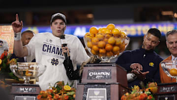 Notre Dame Fighting Irish quarterback Riley Leonard and Notre Dame Fighting Irish head coach Marcus Freeman celebrate