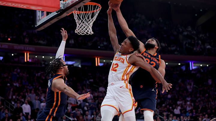 Dec 11, 2024; New York, New York, USA; New York Knicks center Karl-Anthony Towns (32) blocks a shot by Atlanta Hawks forward De'Andre Hunter (12) in front of Knicks guard Jalen Brunson (11) during the second quarter at Madison Square Garden. Mandatory Credit: Brad Penner-Imagn Images Dec 11, 2024; New York, New York, USA; New York Knicks center Karl-Anthony Towns (32) blocks a shot by Atlanta Hawks forward De'Andre Hunter (12) in front of Knicks guard Jalen Brunson (11) during the second quarter at Madison Square Garden. Mandatory Credit: Brad Penner-Imagn Images