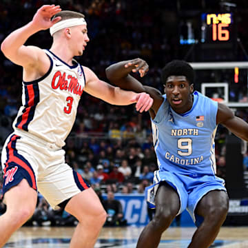 Mar 21, 2025; Milwaukee, WI, USA; North Carolina Tar Heels guard Drake Powell (9) drives against Mississippi Rebels guard Sean Pedulla (3) during the first half of a first round NCAA men’s tournament game at Fiserv Forum. 
