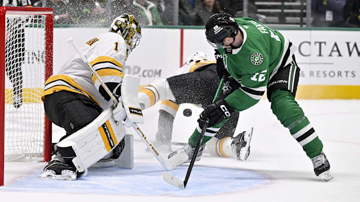 Jan 20, 2026; Dallas, Texas, USA;  Dallas Stars center Radek Faksa (12) looks to redirect the puck past Boston Bruins goaltender Jeremy Swayman (1) during the second period at the American Airlines Center. Mandatory Credit: Jerome Miron-Imagn Images