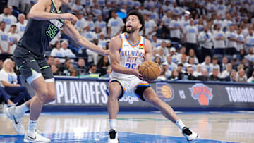 May 20, 2025; Oklahoma City, Oklahoma, USA; Oklahoma City Thunder guard Ajay Mitchell (25) drives to the basket against Minnesota Timberwolves center Luka Garza (55) in the fourth quarter during game one of the western conference finals for the 2025 NBA Playoffs at Paycom Center. Mandatory Credit: Alonzo Adams-Imagn Images