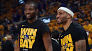 May 10, 2025; San Francisco, California, USA; Golden State Warriors forward Jonathan Kuminga (00) and guard Gary Payton II (0) warm up before Game 3 of the second round for the 2025 NBA Playoffs against the Minnesota Timberwolves at Chase Center.