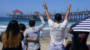 Aug 2, 2023; Huntington Beach, CA, USA; Fans of Filipino surfer Rogelio Jr Esquievel  cheer as he competes in the Huntington Beach Longboard Classic at the 2023 US Open of Surfing. Mandatory Credit: Robert Hanashiro-USA TODAY