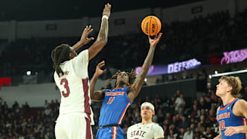 Feb 11, 2025; Starkville, Mississippi, USA; Florida Gators guard Denzel Aberdeen (11) shoots against Mississippi State Bulldogs forward KeShawn Murphy (3) during the first half at Humphrey Coliseum. Mandatory Credit: Wesley Hale-Imagn Images