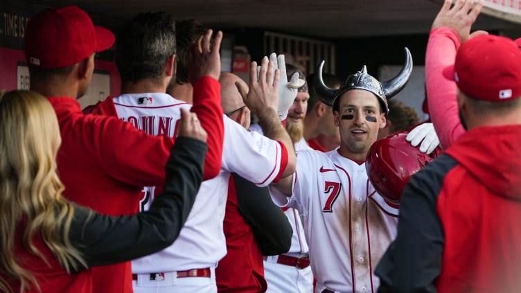 After scoring a home run, Spencer Steer is greeted by teammates