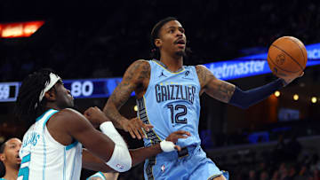 Jan 22, 2025; Memphis, Tennessee, USA; Memphis Grizzlies guard Ja Morant (12) drives to the basket as Charlotte Hornets center Mark Williams (5) defends during the third quarter at FedExForum. Mandatory Credit: Petre Thomas-Imagn Images