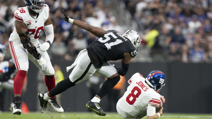 November 5, 2023; Paradise, Nevada, USA; New York Giants quarterback Daniel Jones (8) falls to the ground against Las Vegas Raiders defensive end Malcolm Koonce (51) during the second quarter at Allegiant Stadium. Mandatory Credit: Kyle Terada-USA TODAY Sports