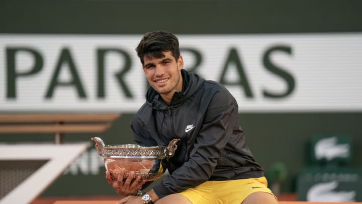 Jun 9, 2024; Paris, France; Carlos Alcaraz of Spain poses with the trophy after winning the men’s singles final against Alexander Zverev of Germany on day 15 of Roland Garros at Stade Roland Garros.