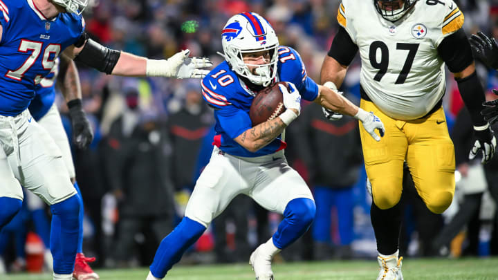 Jan 15, 2024; Orchard Park, New York, USA; Buffalo Bills wide receiver Khalil Shakir (10) runs for a touchdown  after a catch with Pittsburgh Steelers defensive tackle Cameron Heyward (97) chasing in the fourth quarter of a 2024 AFC wild card game at Highmark Stadium. Mandatory Credit: Mark Konezny-USA TODAY Sports