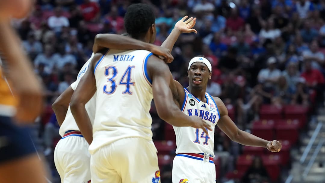 Mar 20, 2026; San Diego, CA, USA; Kansas Jayhawks guard Melvin Council Jr. (14) and center Paul Mbiya (34) react in the first half against the California Baptist Lancers during a first round game of the men's 2026 NCAA Tournament at Viejas Arena. Mandatory Credit: Kirby Lee-Imagn Images