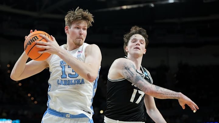 Mar 19, 2026; Greenville, SC, USA; North Carolina Tar Heels center Henri Veesaar (13) rebounds the ball against VCU Rams forward Lazar Djokovic (17) in the first half of a first round game of the men's 2026 NCAA Tournament at Bon Secours Wellness Arena. Mandatory Credit: Bob Donnan-Imagn Images