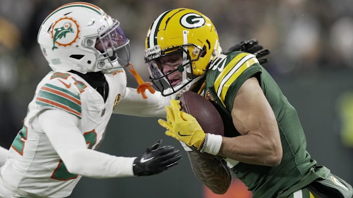 Green Bay Packers' Christian Watson (9) makes a 21-yard reception before being tackled by Miami Dolphins cornerback Cam Smith (24) during the second quarter at Lambeau Field. Green Bay Packers' Christian Watson (9) makes a 21-yard reception before being tackled by Miami Dolphins cornerback Cam Smith (24) during the second quarter at Lambeau Field.