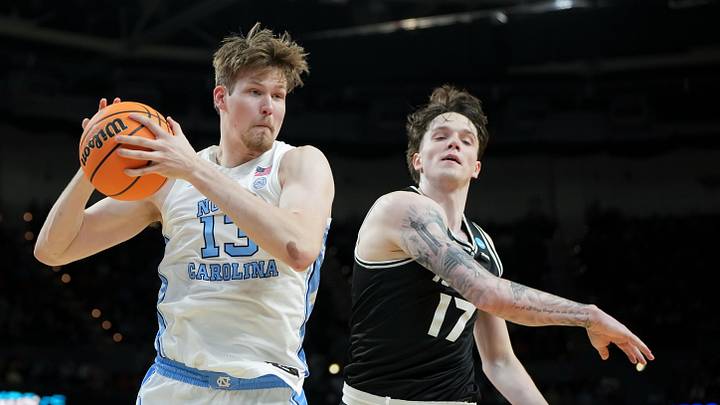 Mar 19, 2026; Greenville, SC, USA; North Carolina Tar Heels center Henri Veesaar (13) rebounds the ball against VCU Rams forward Lazar Djokovic (17) in the first half of a first round game of the men's 2026 NCAA Tournament at Bon Secours Wellness Arena. Mandatory Credit: Bob Donnan-Imagn Images