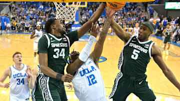 Feb 4, 2025; Los Angeles, California, USA; Michigan State Spartans forward Xavier Booker (34) and guard Tre Holloman (5) defend a shot by UCLA Bruins guard Sebastian Mack (12) in the first half at Pauley Pavilion presented by Wescom. Mandatory Credit: Jayne Kamin-Oncea-Imagn Images
