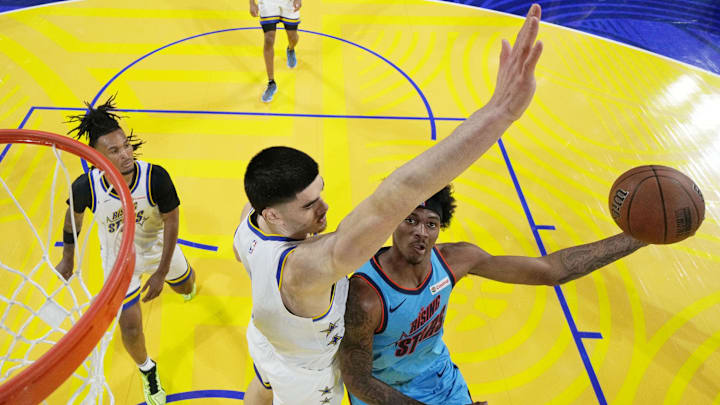 February 14, 2025; San Francisco, California, USA; Team G-League guard Dink Pate (1) of the Mexico City Capitanes drives to the basket against Team C forward Zach Edey (14) of the Memphis Grizzlies during the 2025 NBA Rising Stars Game at Chase Center. Mandatory Credit: Kyle Terada-Imagn Images