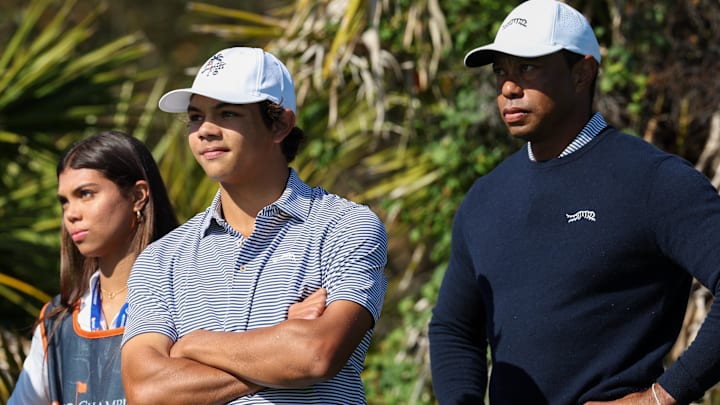 Tiger Woods, with Charlie and daughter Sam, has a share of the first-round lead at the PNC Championship. Tiger Woods, with Charlie and daughter Sam, has a share of the first-round lead at the PNC Championship.