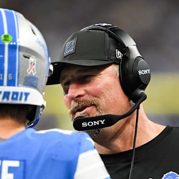 Detroit Lions head coach Dan Campbell speaks with quarterback Jared Goff (16) in the third quarter against the Vikings