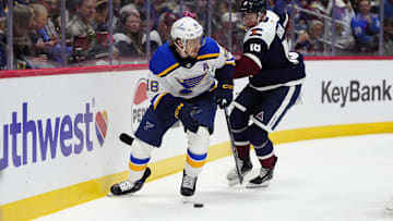 Mar 29, 2025; Denver, Colorado, USA; St. Louis Blues center Robert Thomas (18) and Colorado Avalanche center Jack Drury (18) at Ball Arena. Mandatory Credit: Ron Chenoy-Imagn Images