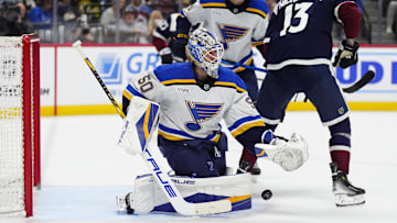 Mar 29, 2025; Denver, Colorado, USA; St. Louis Blues goaltender Jordan Binnington (50) makes a save in the second period against the Colorado Avalanche at Ball Arena. Mandatory Credit: Ron Chenoy-Imagn Images
