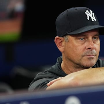 Jul 1, 2025; Toronto, Ontario, CAN; New York Yankees manager Aaron Boone (17) watches batting practice before a game against the Toronto Blue Jays at Rogers Centre. Mandatory Credit: Nick Turchiaro-Imagn Images