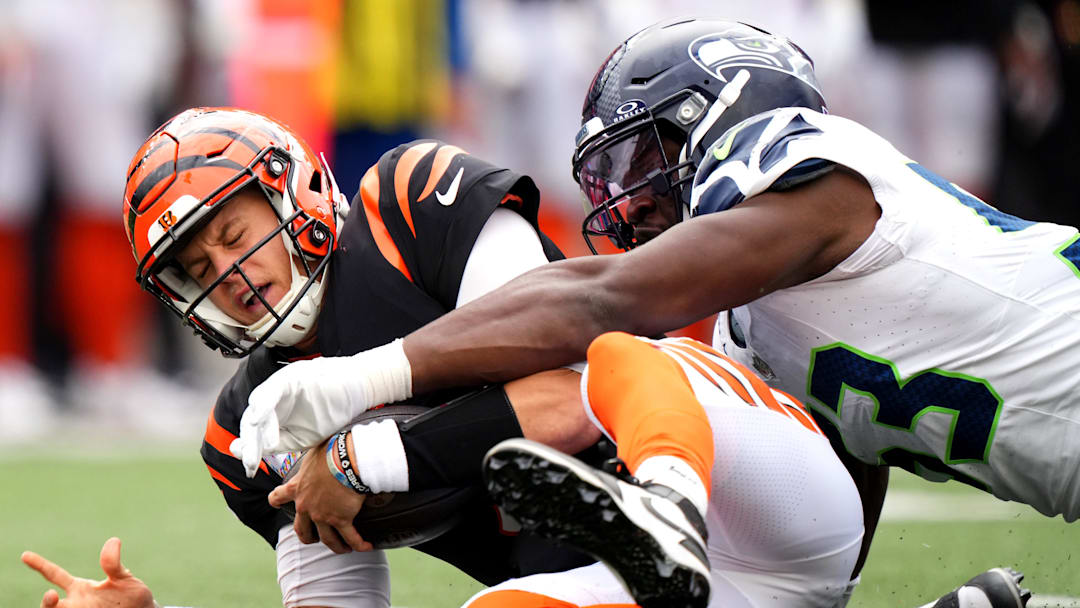 Cincinnati Bengals quarterback Joe Burrow (9) is sacked by Seattle Seahawks linebacker Boye Mafe (53) in the fourth quarter during an NFL football game between the Seattle Seahawks and the Cincinnati Bengals Sunday, Oct. 15, 2023, at Paycor Stadium in Cincinnati. The Cincinnati Bengals won, 17-13.