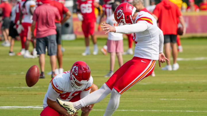 Jul 26, 2024; Kansas City, MO, USA; Kansas City Chiefs kicker Harrison Butker (7) kicks as punter Matt Araiza (49) holds during training camp at Missouri Western State University. Mandatory Credit: Denny Medley-USA TODAY Sports