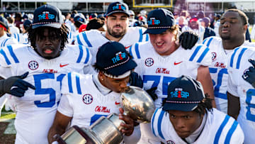 Ole Miss quarterback Trinidad Chambliss (6) kisses the Golden Egg trophy while posing for a picture with teammates after a college football game between Mississippi State and Ole Miss at Davis Wade Stadium in Starkville, Miss., on Friday, Nov. 28, 2025. Ole Miss defeated Mississippi State 38-19 in the Egg Bowl.