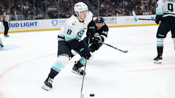 Apr 7, 2025; Los Angeles, California, USA;  Seattle Kraken defenseman Cale Fleury (8) skates with the puck against Los Angeles Kings left wing Trevor Moore (12) during the second period at Crypto.com Arena. Mandatory Credit: Kiyoshi Mio-Imagn Images