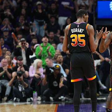 Apr 28, 2024; Phoenix, Arizona, USA; Phoenix Suns forward Kevin Durant (35) and Phoenix Suns forward Royce O'Neale (00) celebrate against the Minnesota Timberwolves during the first half of game four of the first round for the 2024 NBA playoffs at Footprint Center. Mandatory Credit: Joe Camporeale-Imagn Images