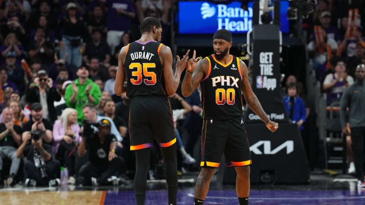 Apr 28, 2024; Phoenix, Arizona, USA; Phoenix Suns forward Kevin Durant (35) and Phoenix Suns forward Royce O'Neale (00) celebrate against the Minnesota Timberwolves during the first half of game four of the first round for the 2024 NBA playoffs at Footprint Center. Mandatory Credit: Joe Camporeale-USA TODAY Sports