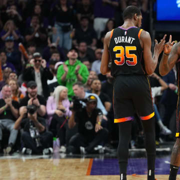 Apr 28, 2024; Phoenix, Arizona, USA; Phoenix Suns forward Kevin Durant (35) and Phoenix Suns forward Royce O'Neale (00) celebrate against the Minnesota Timberwolves during the first half of game four of the first round for the 2024 NBA playoffs at Footprint Center. Mandatory Credit: Joe Camporeale-USA TODAY Sports