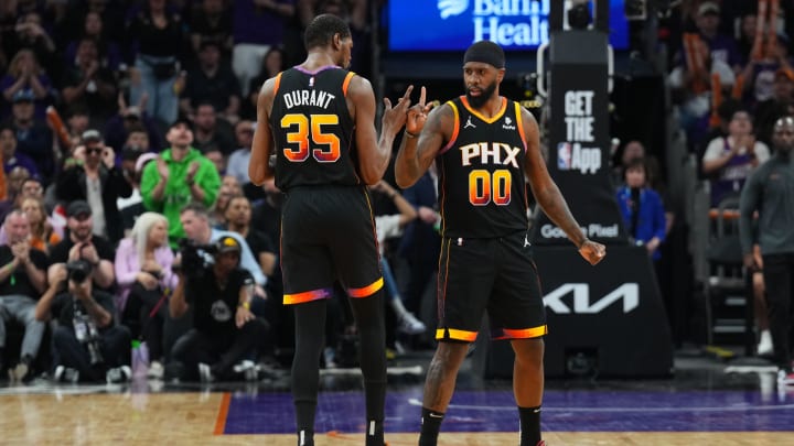 Apr 28, 2024; Phoenix, Arizona, USA; Phoenix Suns forward Kevin Durant (35) and Phoenix Suns forward Royce O'Neale (00) celebrate against the Minnesota Timberwolves during the first half of game four of the first round for the 2024 NBA playoffs at Footprint Center. Mandatory Credit: Joe Camporeale-USA TODAY Sports