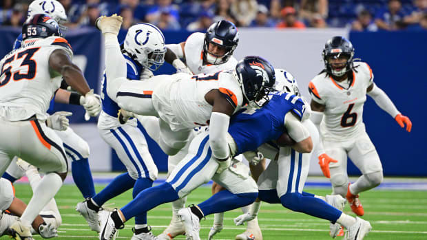 Denver Broncos defensive tackle Malcolm Roach (97) jumps to tackle Indianapolis Colts quarterback Sam Ehlinger (4).