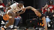 Feb 8, 2025; Louisville, Kentucky, USA;  Miami (Fl) Hurricanes guard Paul Djobet (10) dribbles against Louisville Cardinals forward Khani Rooths (9) during the second half at KFC Yum! Center. Louisville defeated Miami 88-78. Mandatory Credit: Jamie Rhodes-Imagn Images